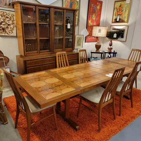 Walnut mid-century dining table and chairs in front of a china hutch at Picker Joe's Antique Mall in Savannah, GA