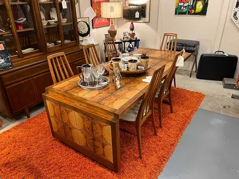 Wood dining table set on an orange shag rug at Picker Joe's Antique Mall in Savannah, GA