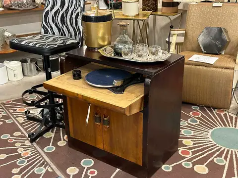 Small bar cabinet with a black swivel stool on an atomic rug at Picker Joe's Antique Mall in Savannah, GA
