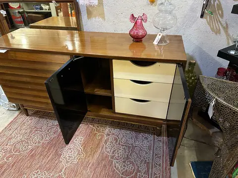 Mid-century chest with white drawers and a black glass door at Picker Joe's Antique Mall in Savannah, GA