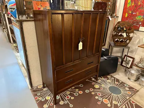 Walnut armoire chest on an atomic-pattern rug at Picker Joe's Antique Mall in Savannah, GA
