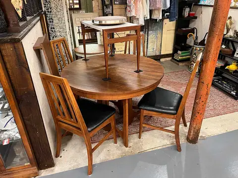 Round dining table with wood chairs at Picker Joe's Antique Mall in Savannah, GA