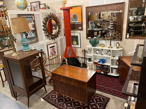 Small walnut chest and side table in a booth with art at Picker Joe's Antique Mall in Savannah, GA