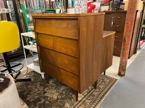 Walnut highboy with a yellow mid-century chair at Picker Joe's Antique Mall in Savannah, GA