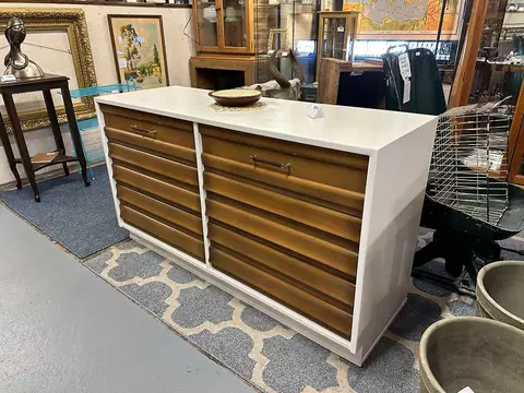 Mid-century dresser with a white case and striped wood drawers at Picker Joe's Antique Mall in Savannah, GA