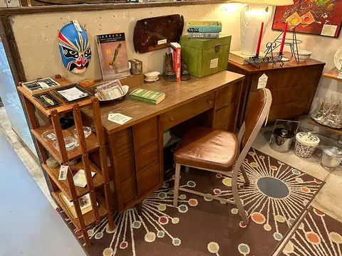 Walnut desk on an atomic starburst rug at Picker Joe's Antique Mall in Savannah, GA