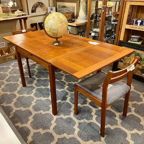 Wood dining table with a globe on a gray trellis rug at Picker Joe's Antique Mall in Savannah, GA
