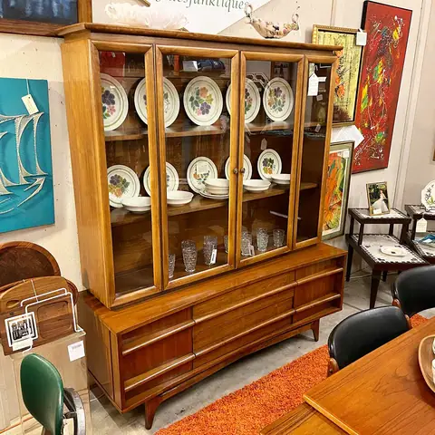 Mid-century china hutch with plates on display at Picker Joe's Antique Mall in Savannah, GA