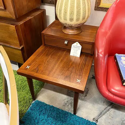Walnut step end table beside a red chair at Picker Joe's Antique Mall in Savannah, GA