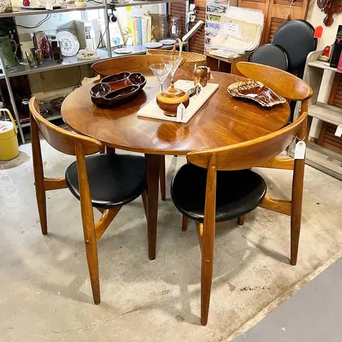 Round dining table with black-seat mid-century chairs at Picker Joe's Antique Mall in Savannah, GA