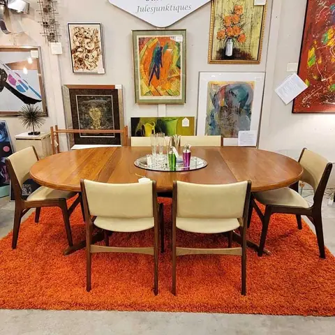 Round dining table with cream chairs on an orange rug at Picker Joe's Antique Mall in Savannah, GA