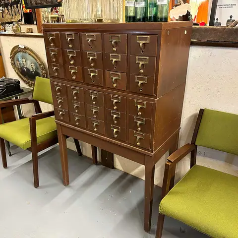 Mid-century card-catalog style cabinet with chartreuse chairs at Picker Joe's Antique Mall in Savannah, GA