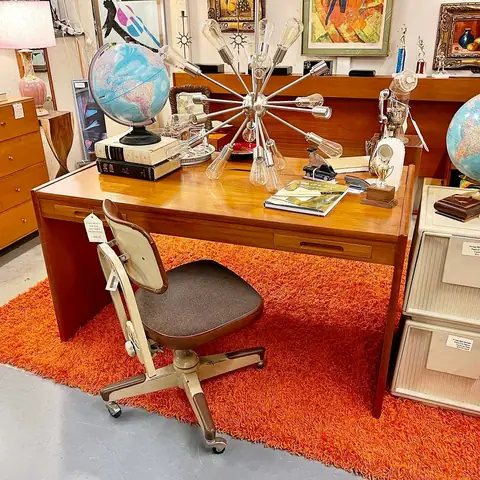 Mid-century desk with a starburst lamp and globes at Picker Joe's Antique Mall in Savannah, GA