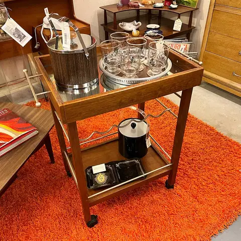 Walnut and brass bar cart on an orange shag rug at Picker Joe's Antique Mall in Savannah, GA