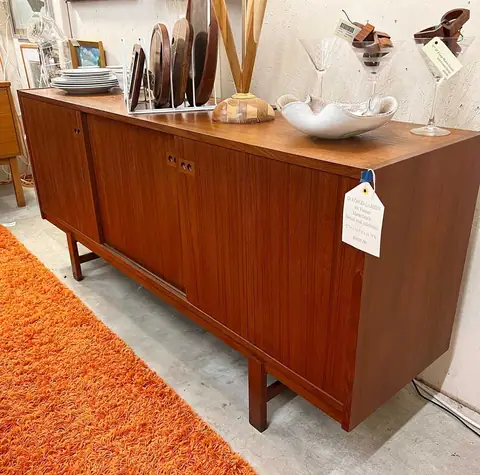 Long walnut credenza with decor at Picker Joe's Antique Mall in Savannah, GA