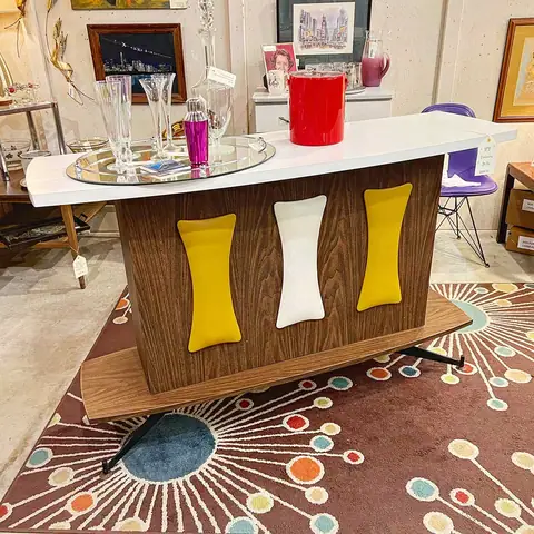 Mid-century bar with yellow accent panels on an atomic rug at Picker Joe's Antique Mall in Savannah, GA