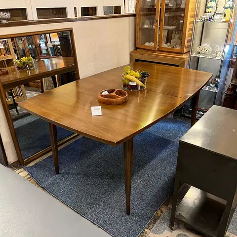 Mid-century dining table on a blue rug at Picker Joe's Antique Mall in Savannah, GA