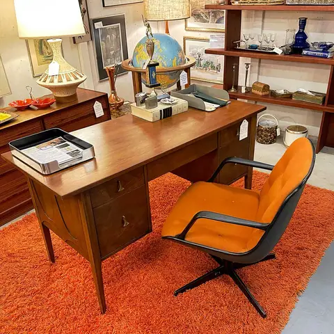 Mid-century executive desk with an orange swivel chair at Picker Joe's Antique Mall in Savannah, GA