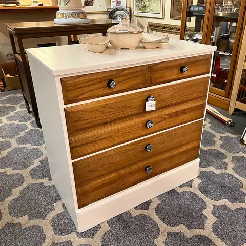 Mid-century chest with a white frame and wood drawers at Picker Joe's Antique Mall in Savannah, GA