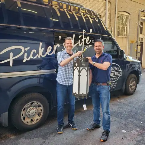Two team members beside the Picker Joe's van at Picker Joe's Antique Mall in Savannah, GA
