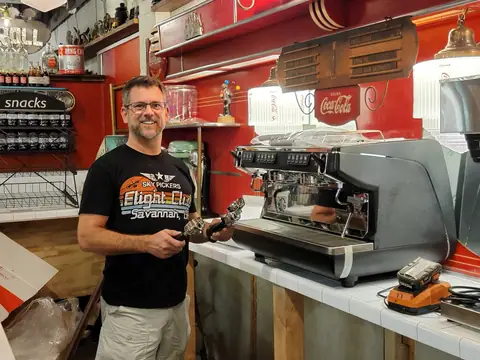 Barista at the espresso machine in the coffee shop at Picker Joe's Antique Mall in Savannah, GA