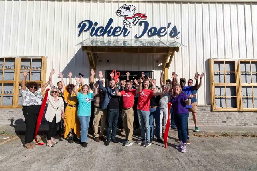 Crowd celebrating in front of the new Picker Joe's storefront at the grand opening